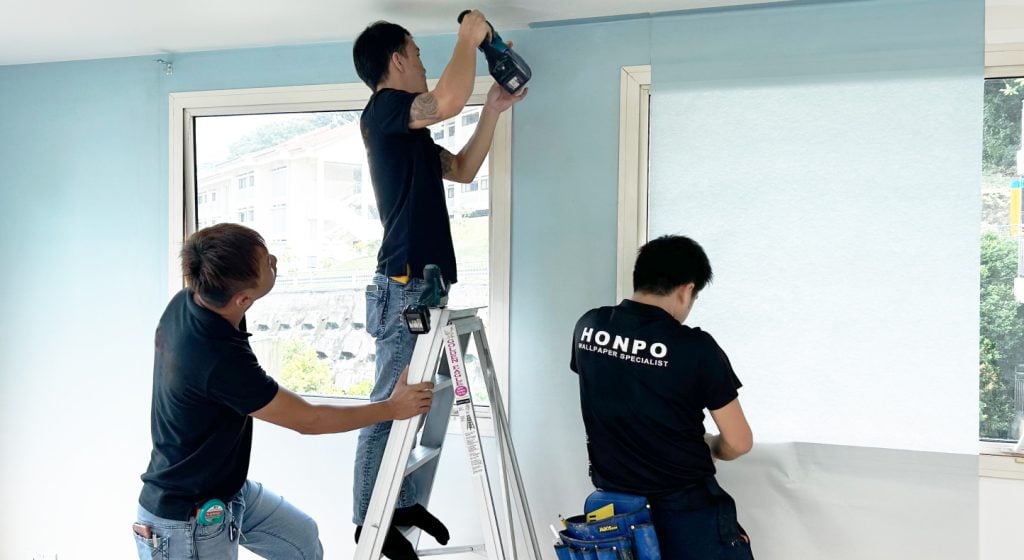 office interior design: process our team installing the wallpaper