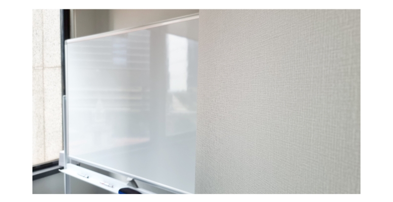 Office with textured wallpaper and whiteboard